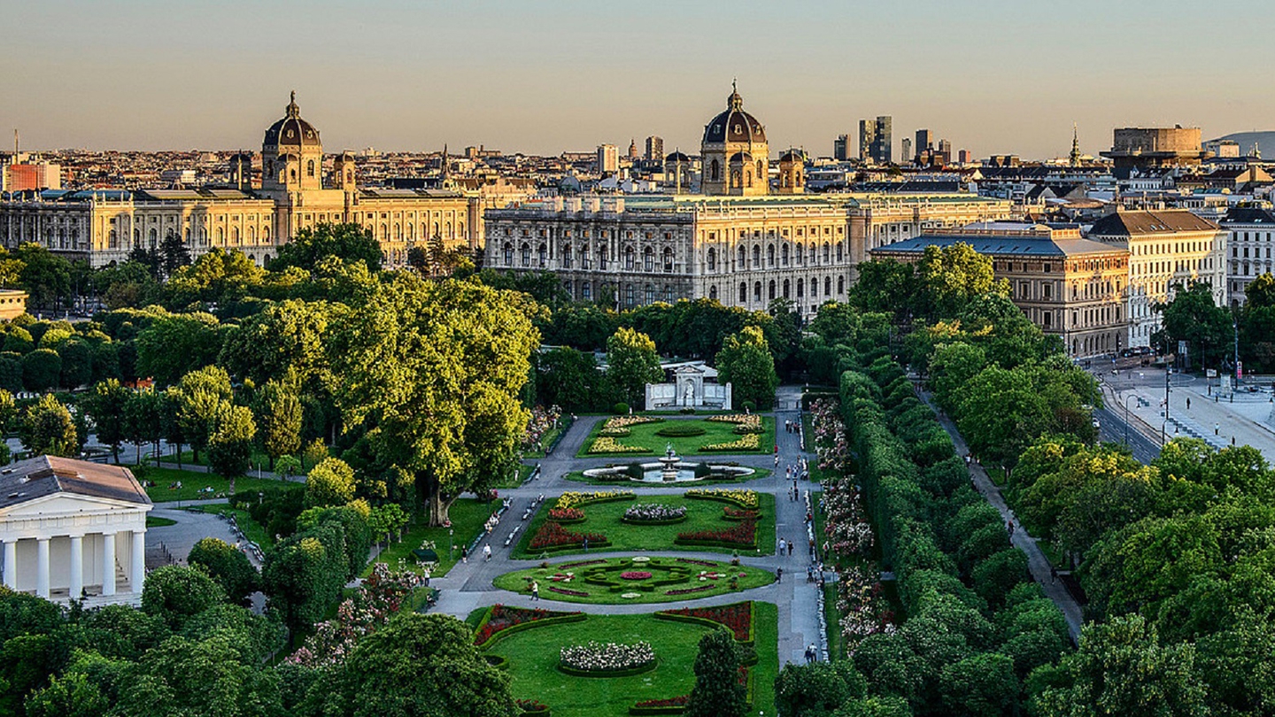 Stunning aerial view of the Vienna City Hall and lush gardens at sunset, showcasing the architectural beauty of Vienna, Austria.