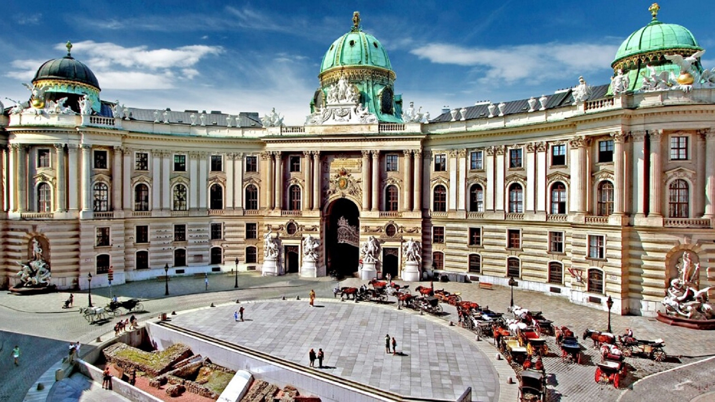 The grandeur of the Hofburg Palace in Vienna, Austria, with its iconic green domes and historic architecture.