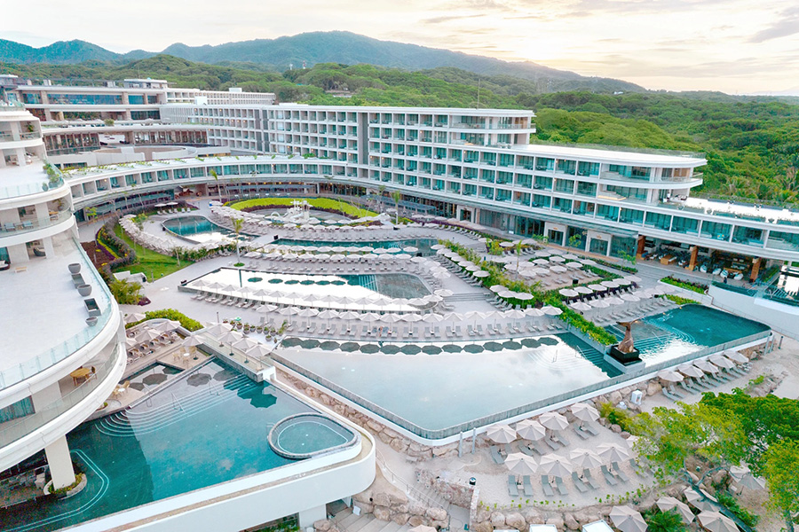 Aerial view of the Dreams Bahia Mita Resort & Spa showcasing its expansive pools, modern architecture, and lush natural surroundings.