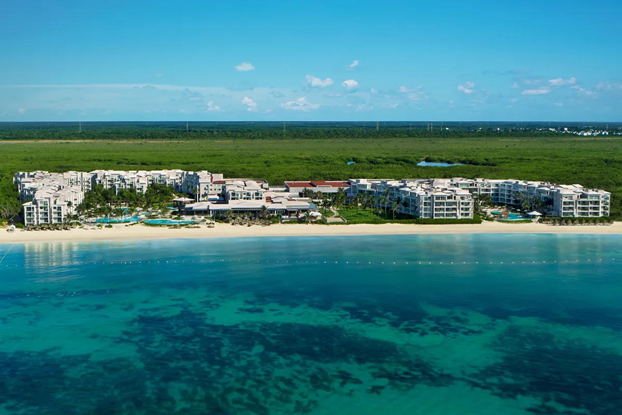 Expansive beachfront property with crystal-clear waters, luxurious amenities, and lush greenery, providing a tranquil escape in Riviera Maya.