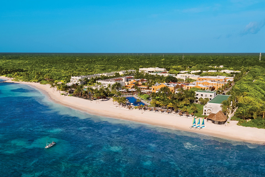 Charming resort blending Mayan culture with modern luxury, featuring serene beaches, lush gardens, and a vibrant turquoise sea.