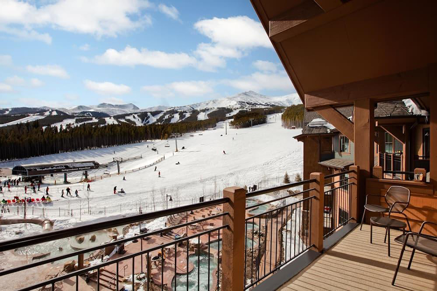 Scenic view from the balcony at Grand Lodge on Peak 7, overlooking snowy ski slopes and mountains in Breckenridge, Colorado.