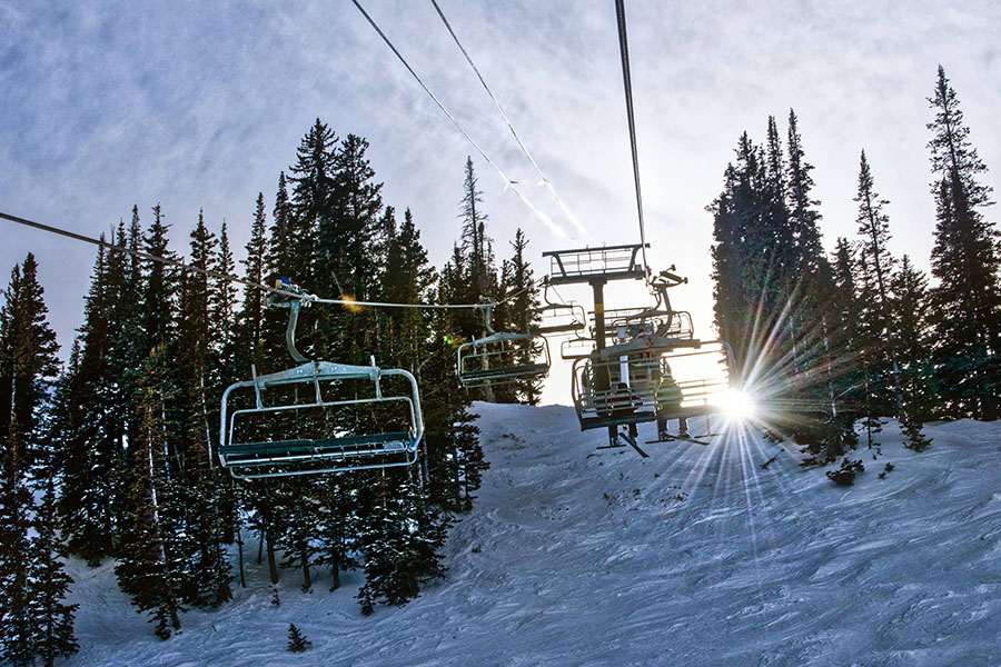 Park City chairlifts ascending the mountain, offering breathtaking alpine scenery.