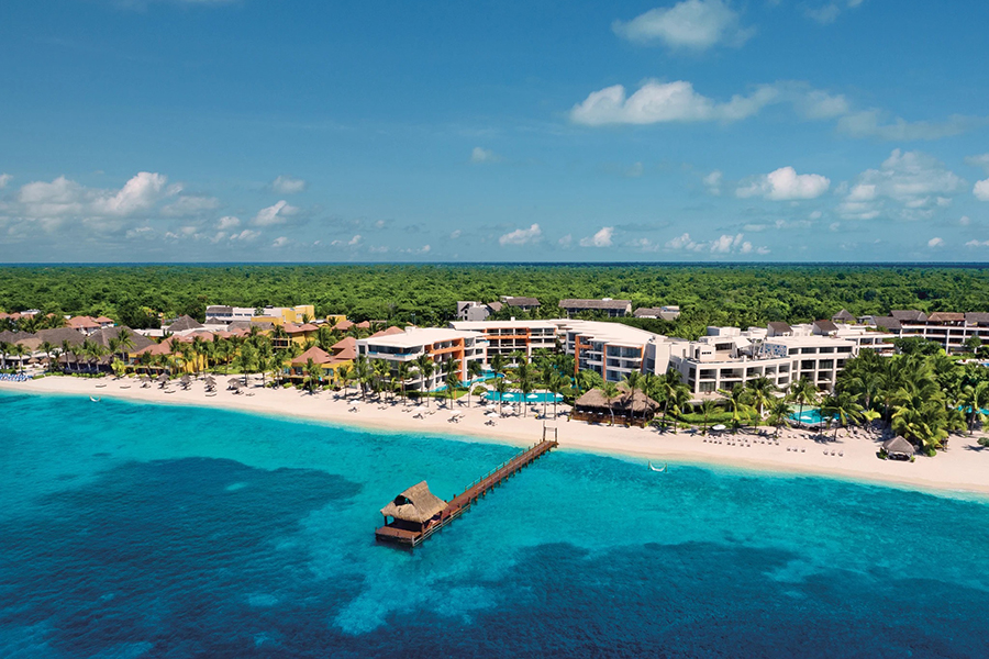 Secluded adults-only retreat with crystal-clear waters, overwater piers, and luxurious suites, perfect for a romantic Caribbean escape.