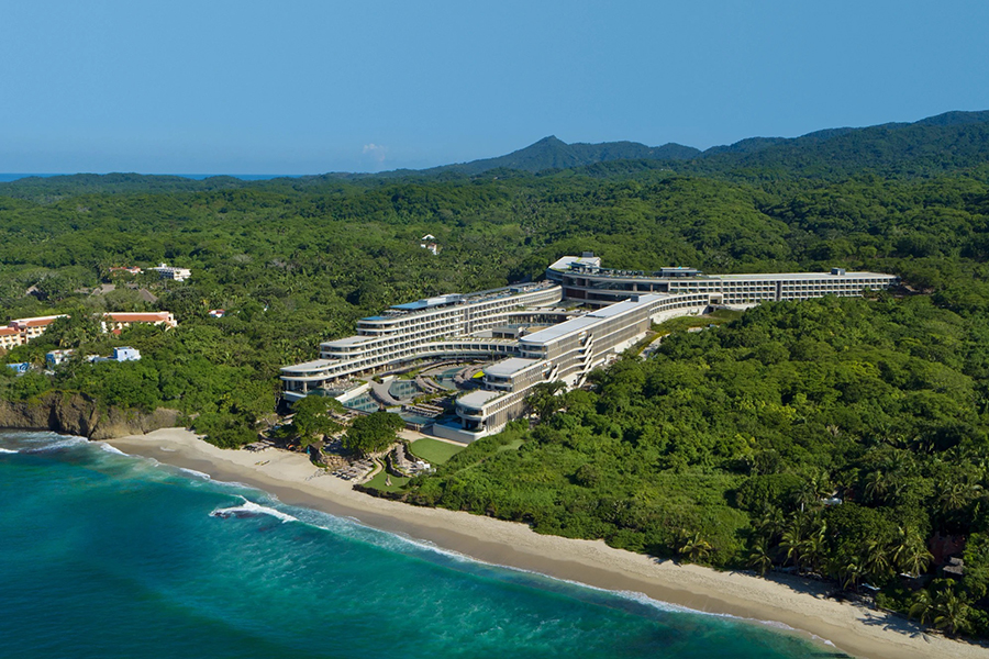 Aerial view of Secrets Bahia Mita Resort, blending modern luxury with lush tropical surroundings and offering panoramic ocean views.